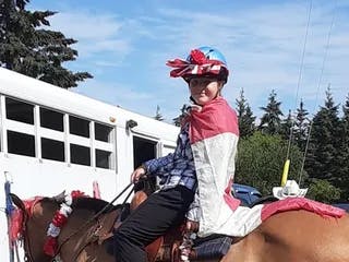 Girl in flamboyant costume on her horse