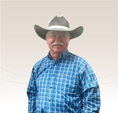 Man with a moustache in a cowboy hat and blue shirt