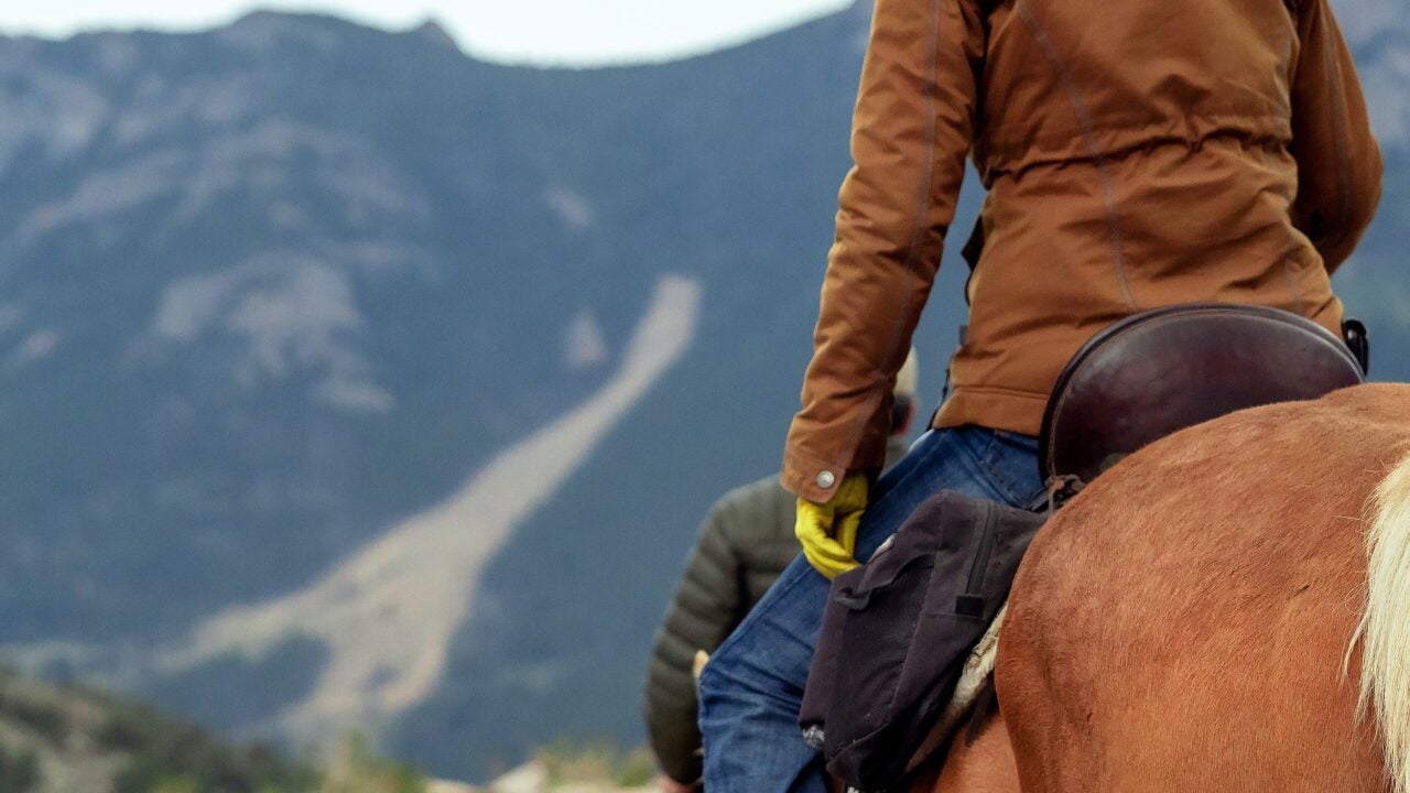 Rider on a horse on a mountain trail
